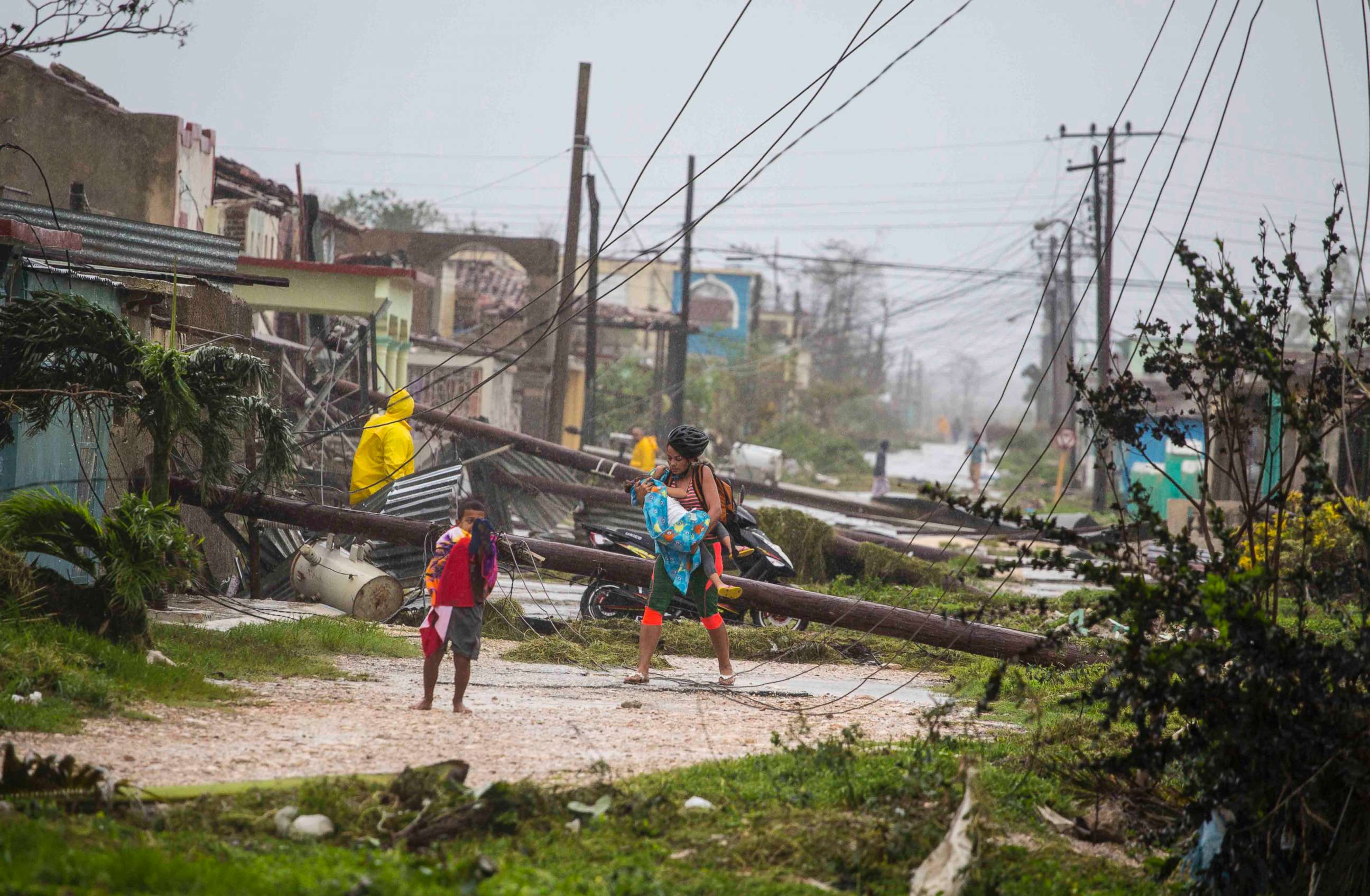 PHOTO: Residents walk near downed power lines felled by Hurricane Irma, in Caibarien, Cuba, Sept. 9, 2017.