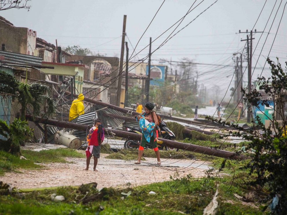 PHOTO: Residents walk near downed power lines felled by Hurricane Irma, in Caibarien, Cuba, Sept. 9, 2017.