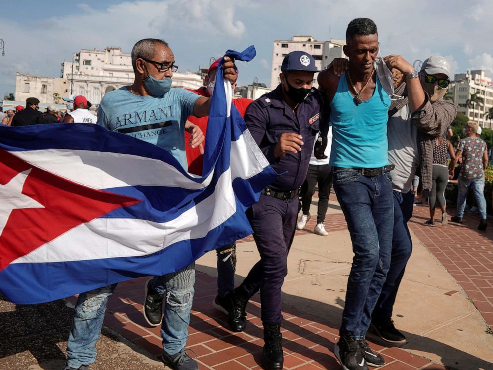 PHOTO: Police detain a person during protests against and in support of the government, amidst the coronavirus disease outbreak, in Havana, Cuba, July 11, 2021.