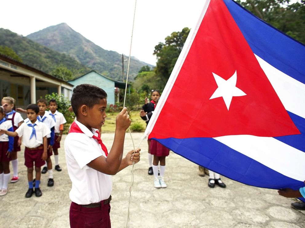 PHOTO: A boy raises the Cuban flag during a daily ceremony held at a school in the village of Santo Domingo, in the Sierra Maestra, Cuba, April 2, 2018.