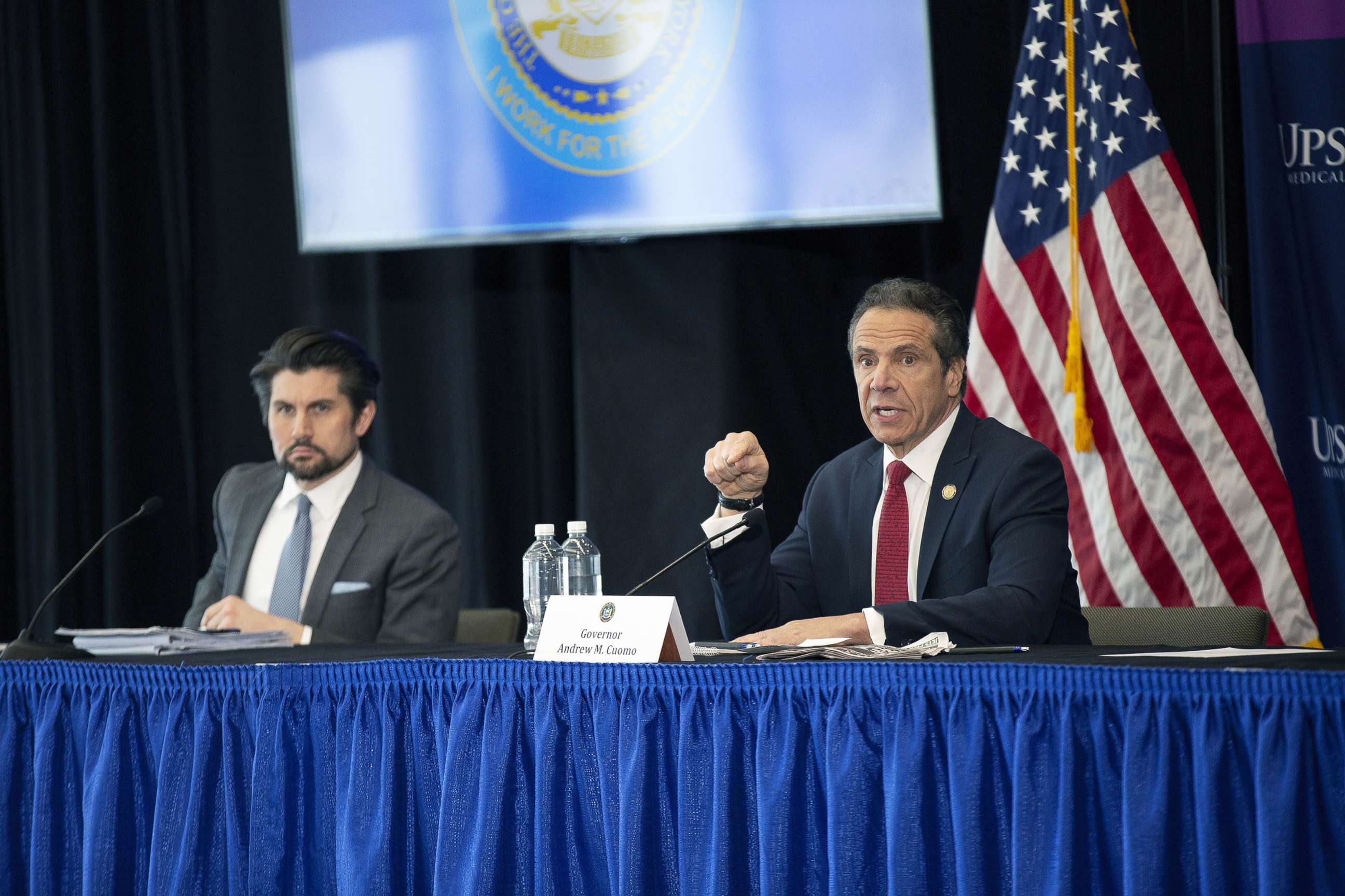 PHOTO: Jim Malatras, President of SUNY Empire State College, left, listens as New York State Governor Andrew Cuomo, right, speaks during his daily coronavirus press briefing at SUNY Upstate Medical University, April 28, 2020 in Syracuse, New York.