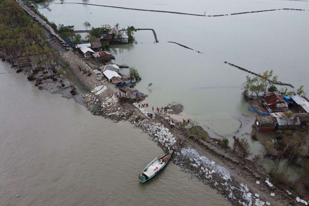 PHOTO: An aerial view shows volunteers and residents working to fix a damaged dam following the landfall of cyclone Amphan in Burigoalini on May 21, 2020.
