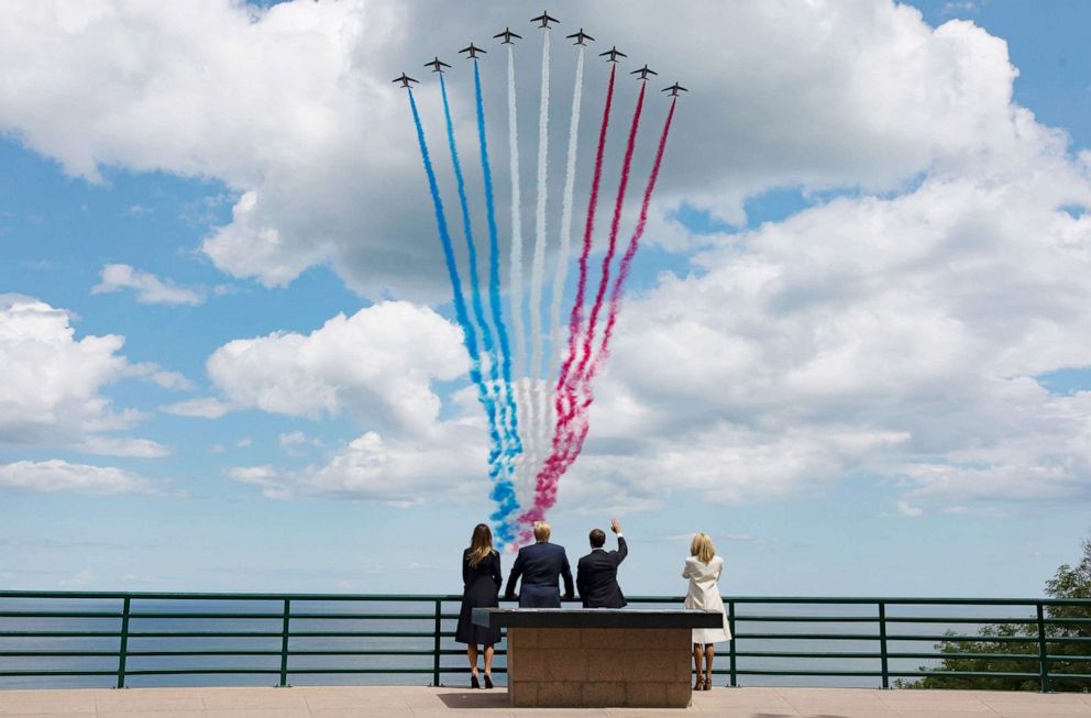 PHOTO: President Donald Trump, First Lady Melania Trump, French President Emmanuel Macron and his wife Brigitte Macron react during the commemoration marking the 75th anniversary of the Allied landings on D-Day in France, June 06, 2019. 