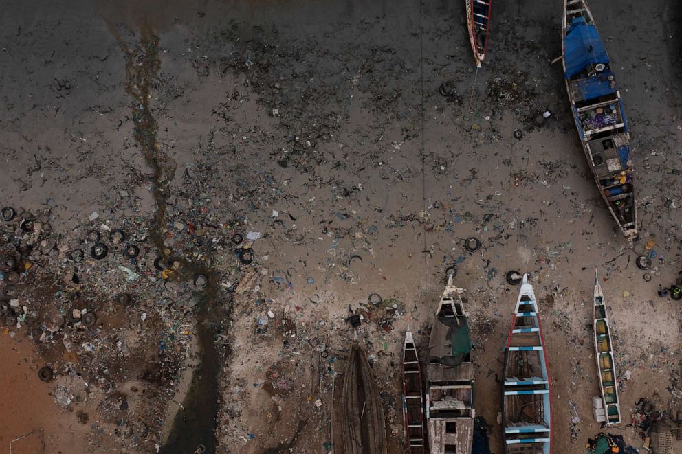 PHOTO: Sewage flows to the ocean next to traditional boats known as pirogues in Dakar, Senegal, Tuesday, Nov. 8, 2022. A boat believed to be a pirogue departed Senegal with more than 100 migrants in early July was rescued on Tuesday, Aug. 16, 2023.