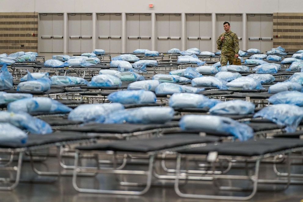 PHOTO: Beds are readied as Texas Army National Guardsmen set up a field hospital in response to the coronavirus pandemic at the Kay Bailey Hutchison Convention Center, March 31, 2020, in Dallas, Texas.