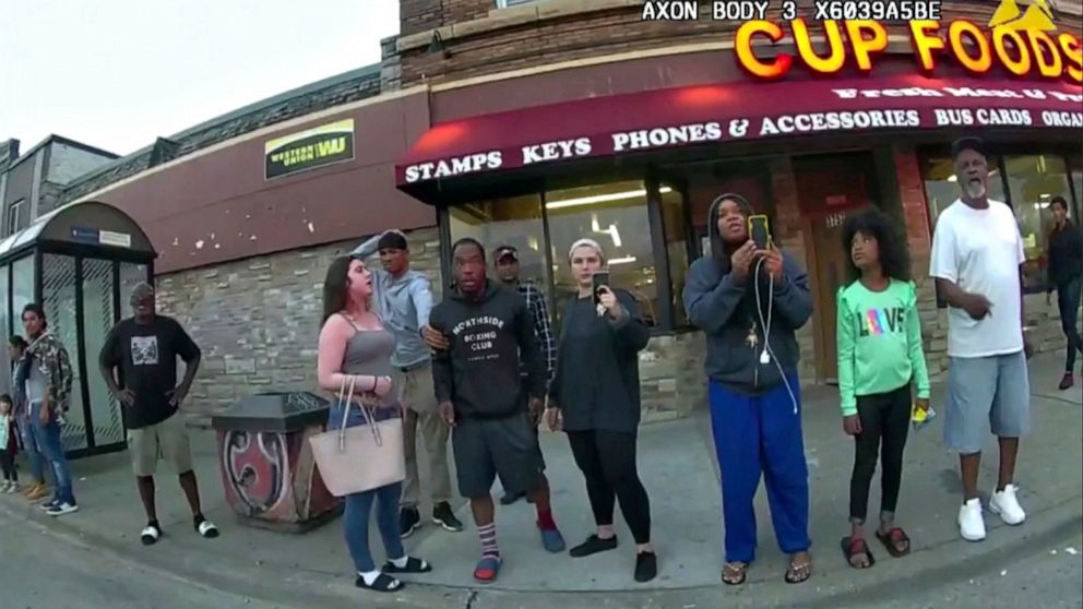 PHOTO: Police body camera image shows bystander Darnella Frazier, third from right, filming, as former Minneapolis police officer Derek Chauvin was recorded pressing his knee on George Floyd's neck for several minutes in Minneapolis, May 25, 2020.