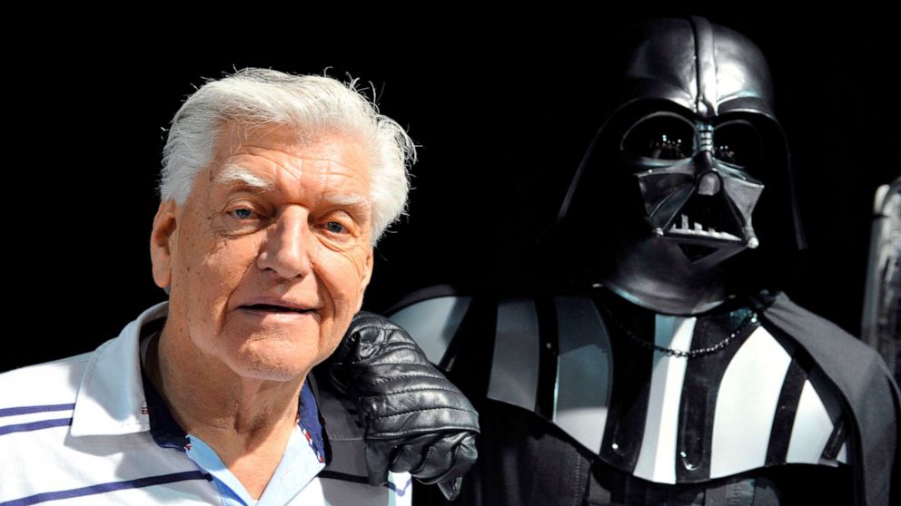 PHOTO: This photo taken on April 27, 2013 during a Star Wars convention in Cusset, France, shows David Prowse, the British actor behind the menacing black mask of Star Wars villain Darth Vader, who died aged 85 his agent said on November 29, 2020. 