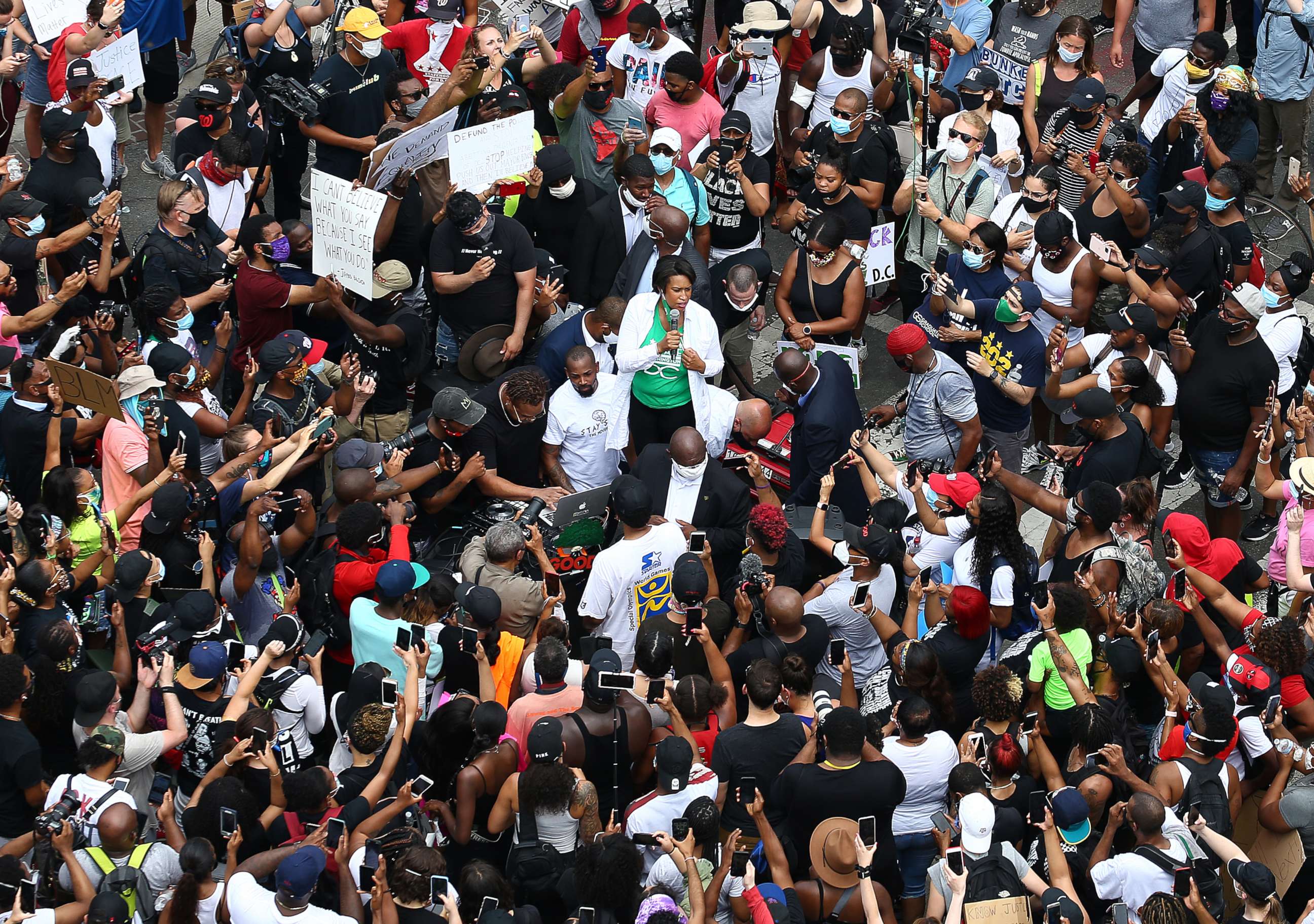 PHOTO: DC Mayor Muriel Bowser, center, speaks to demonstrators gathered on the newly named Black Lives Plaza during a peaceful protest against police brutality and racism, on June 6, 2020 in Washington.