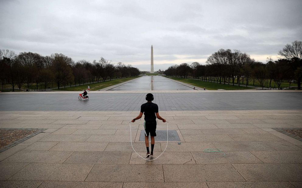 PHOTO: Zef Talahun jumps rope on the plaza in front of the Lincoln Memorial, normally filled with tourists, but now nearly empty due to the impacts of coronavirus (COVID-19) on March 17, 2020 in Washington, D.C.