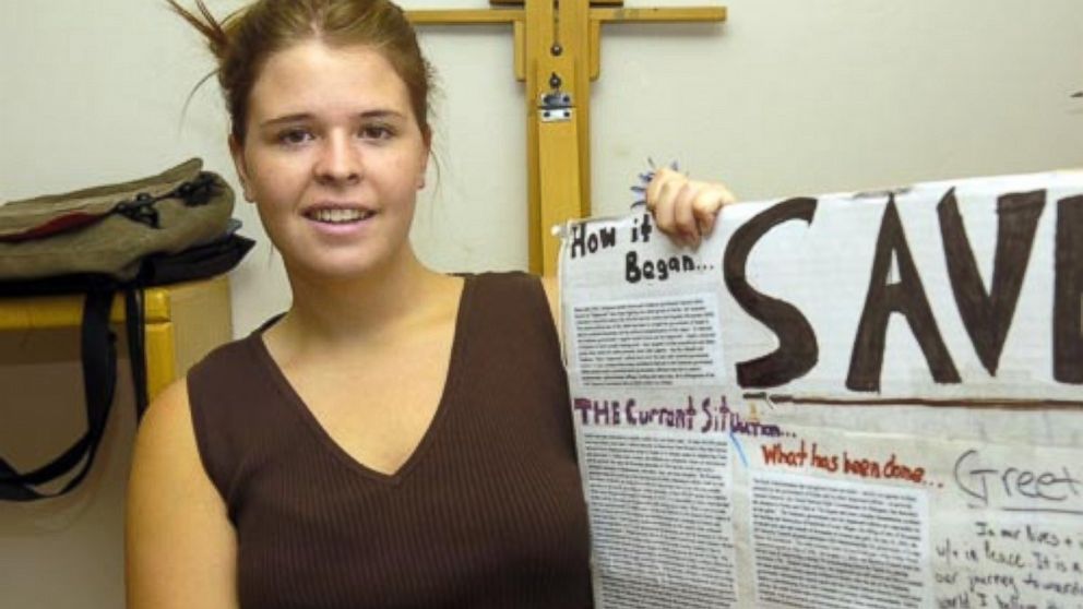 Arizona woman Kayla Mueller shows a sign promoting aid for Darfur in 2007.
