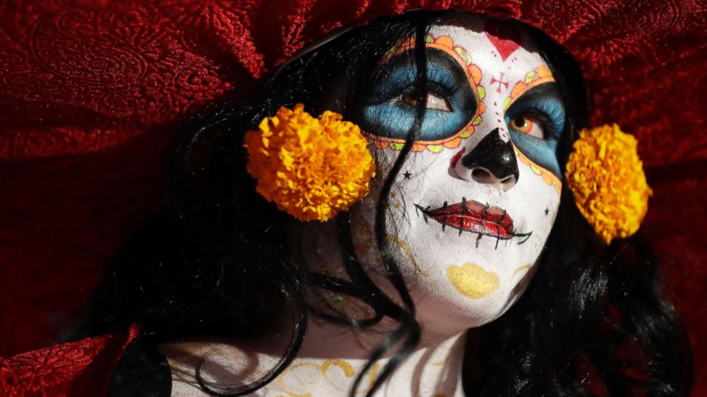 PHOTO: A woman dressed as Mexico's iconic "Catrina" awaits the start of the Grand Procession of the Catrinas, part of upcoming Day of the Dead celebrations in Mexico City, Oct. 22, 2017.