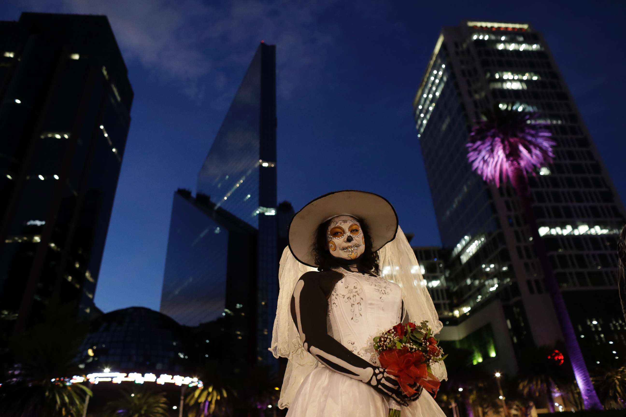 PHOTO: Montserrat Ramirez, dressed as a skeleton bride, poses for pictures during the Grand Procession of the "Catrinas," part of upcoming Day of the Dead celebrations, in Mexico City, Oct. 22, 2017. 