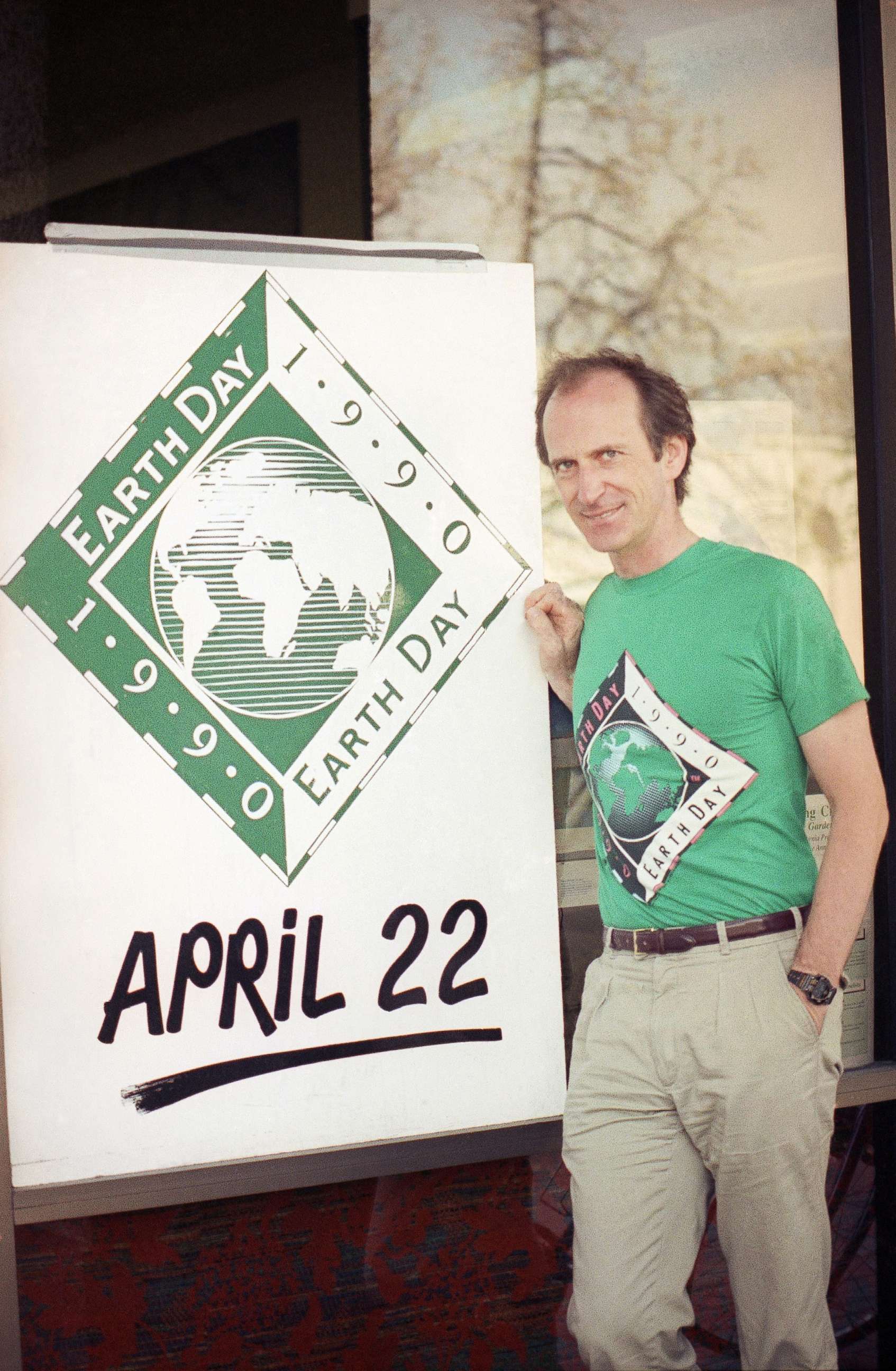 PHOTO: Earth Day founder Denis Hayes poses with an Earth Day sign outside Earth Day headquarters in Palo Alto, Calif., on April 21, 1990, in this file photo. Earth Day is set for April 22 with environmental activities planned throughout the world.
