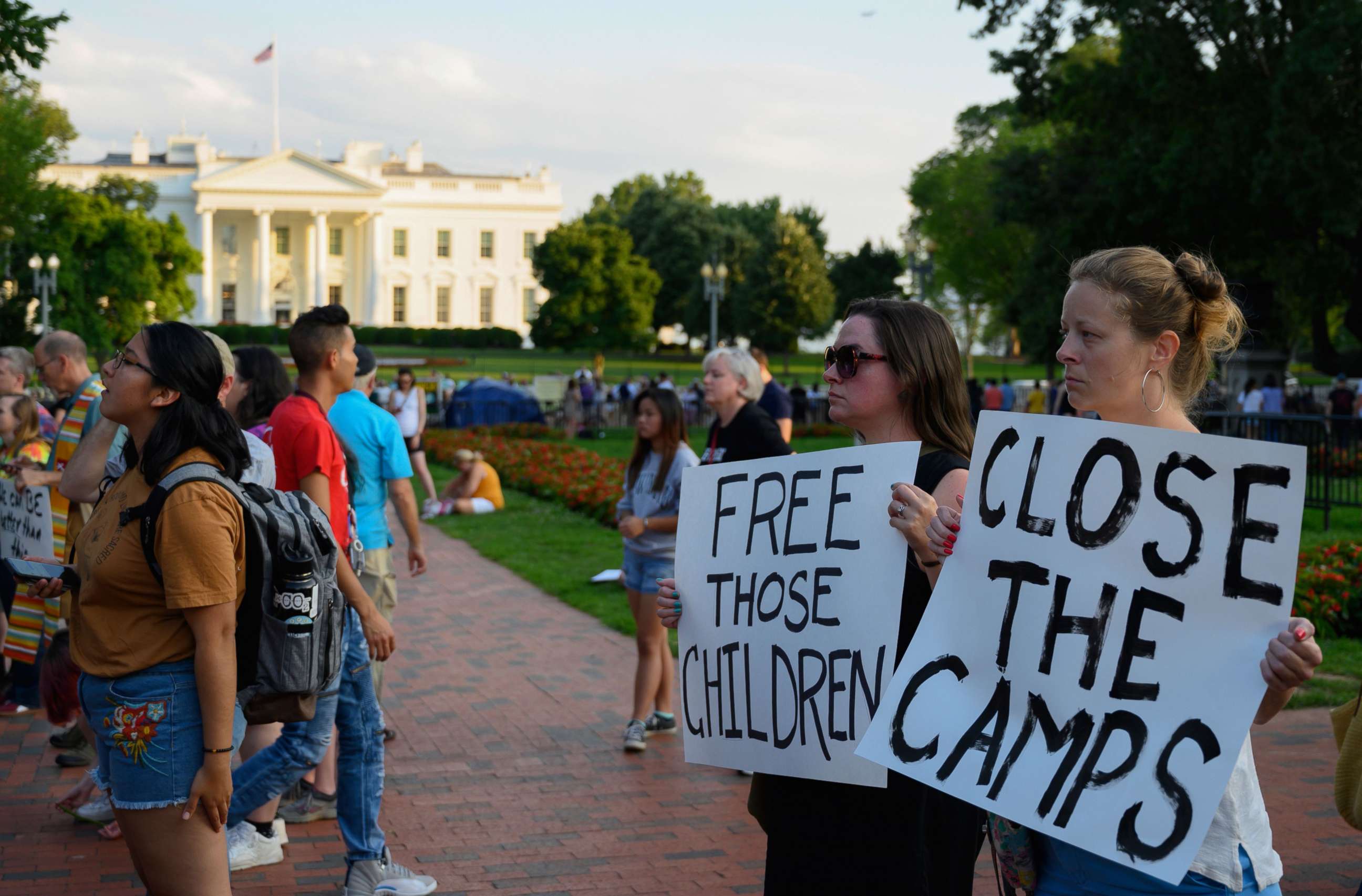 PHOTO: People hold signs during a "Lights For Liberty" rally to demand Border Patrol facilities and migrant detention centers in the United States to be closed down, at Lafayette Square near the White House in Washington, DC, July 12, 2019.