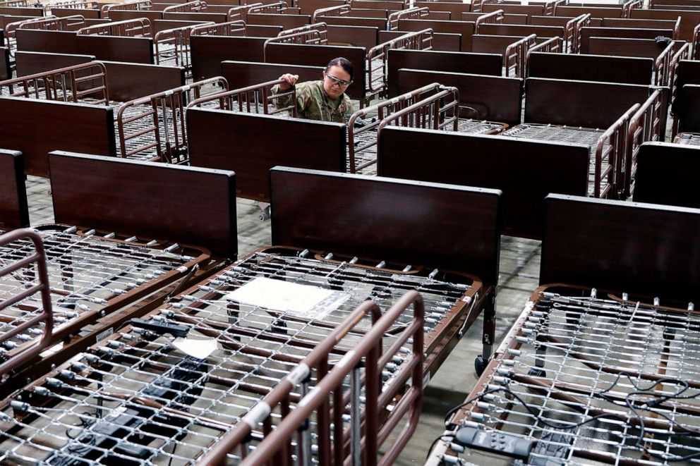 PHOTO: Members of the Michigan National Guard assemble beds at the TCF Center which is being converted by the U.S. Army Corps of Engineers into a field hospital in Detroit, April 1, 2020.