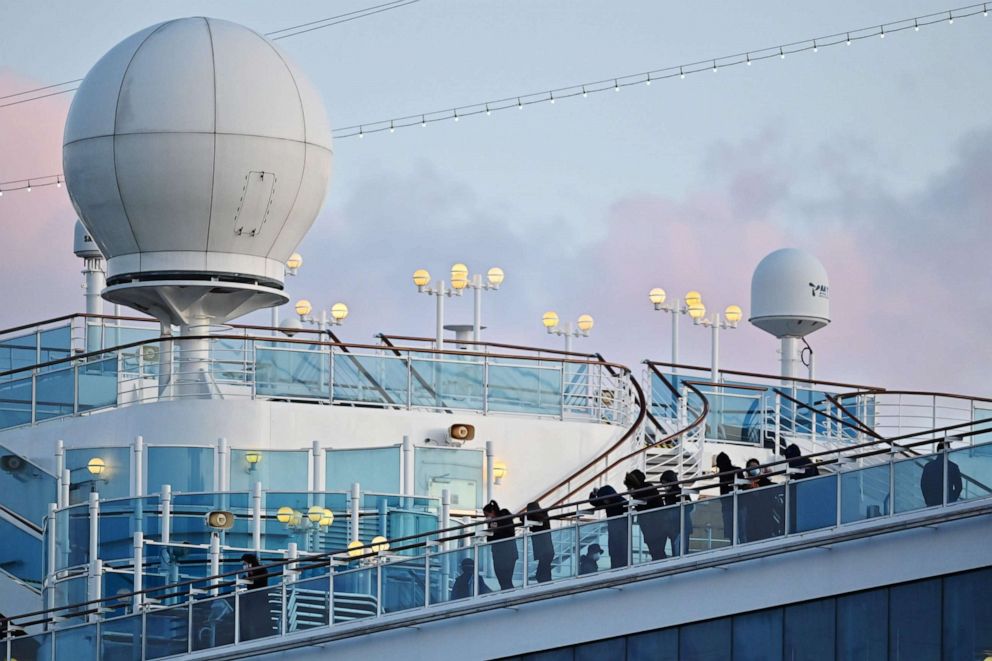 PHOTO: People still in quarantine due to fears of the new coronavirus stand on the deck of the Diamond Princess cruise ship docked at the Daikoku Pier Cruise Terminal in Yokohama, Japan, on Feb. 18, 2020.