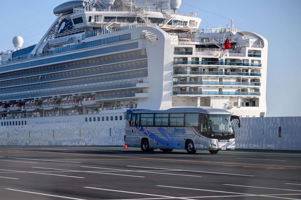 PHOTO: A bus drives through dockside past the Diamond Princess cruise ship, in quarantine due to fears of the  novel coronavirus, at Daikoku Pier Cruise Terminal in Yokohama, Japan, on Feb. 21, 2020.