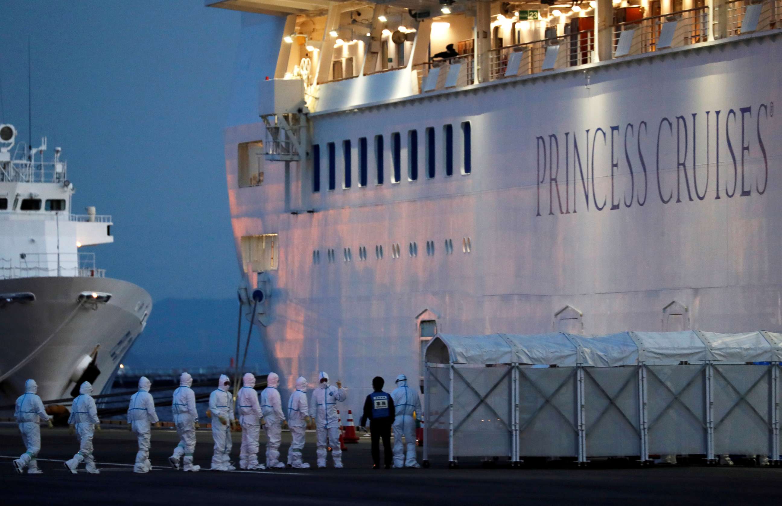 PHOTO: Officers in protective gear enter the Diamond Princess cruise ship to transfer a patient who tested positive for the novel coronavirus to the hospital after the ship arrived at Daikoku Pier Cruise Terminal in Yokohama, Japan, Feb. 7, 2020.