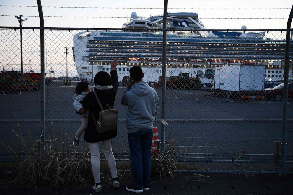 PHOTO: Relatives of passengers wave towards the Diamond Princess cruise ship, with around 3,600 people quarantined on board due to fears of the new coronavirus, at the Daikoku Pier Cruise Terminal in Yokohama, Japan, on Feb. 11, 2020.