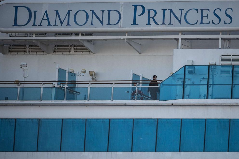 PHOTO: A crew member wearing a face mask walks on the deck of the Diamond Princess cruise ship at Daikoku Pier Cruise Terminal in Yokohama, Japan, on Feb 24, 2020. 