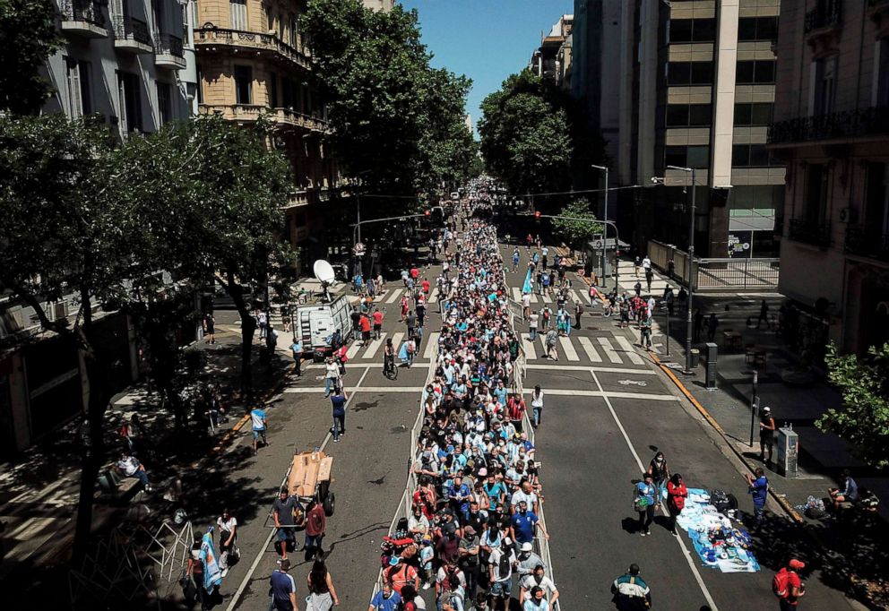 PHOTO: People queue along Avenida de Mayo avenue to reach the Casa Rosada presidential palace to pay tribute to late Argentine football legend Diego Maradona in Buenos Aires, Nov. 26, 2020.