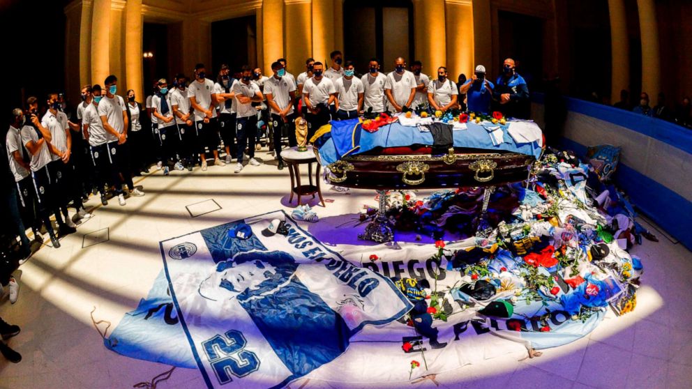 PHOTO: Players from the Argentine soccer team Gimnasia y Esgrima La Plata pay their respects to Diego Maradona at the burning chapel in Casa Rosada presidential palace in Buenos Aires on Nov. 26, 2020.