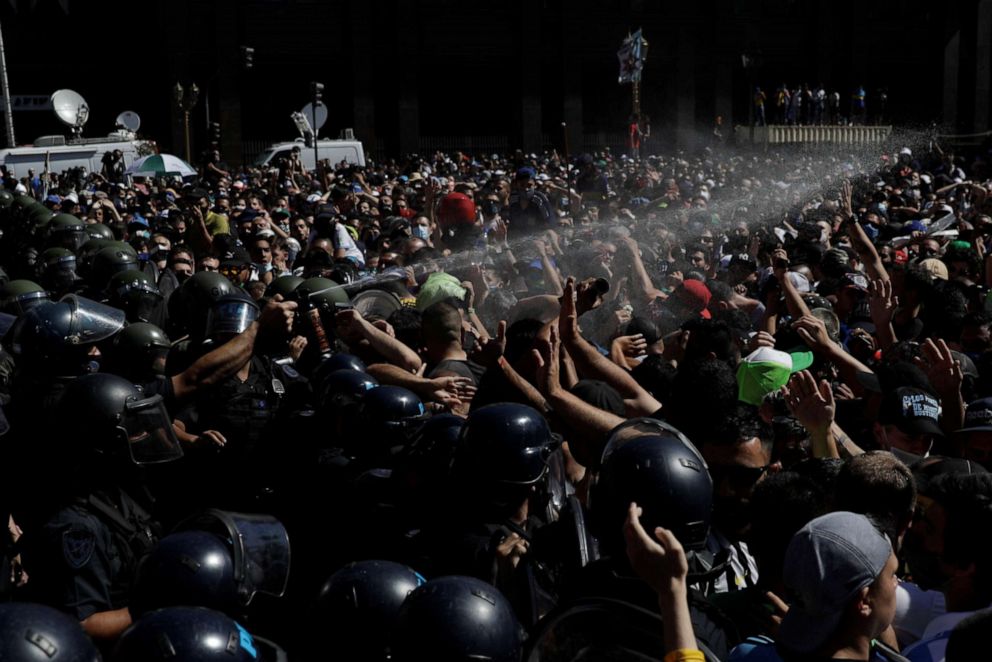 PHOTO: Police use pepper spray as they try to disperse people gathering in front of the Casa Rosada presidential palace to mourn the death of soccer legend Diego Armando Maradona, in Buenos Aires, Argentina, Nov. 26, 2020.