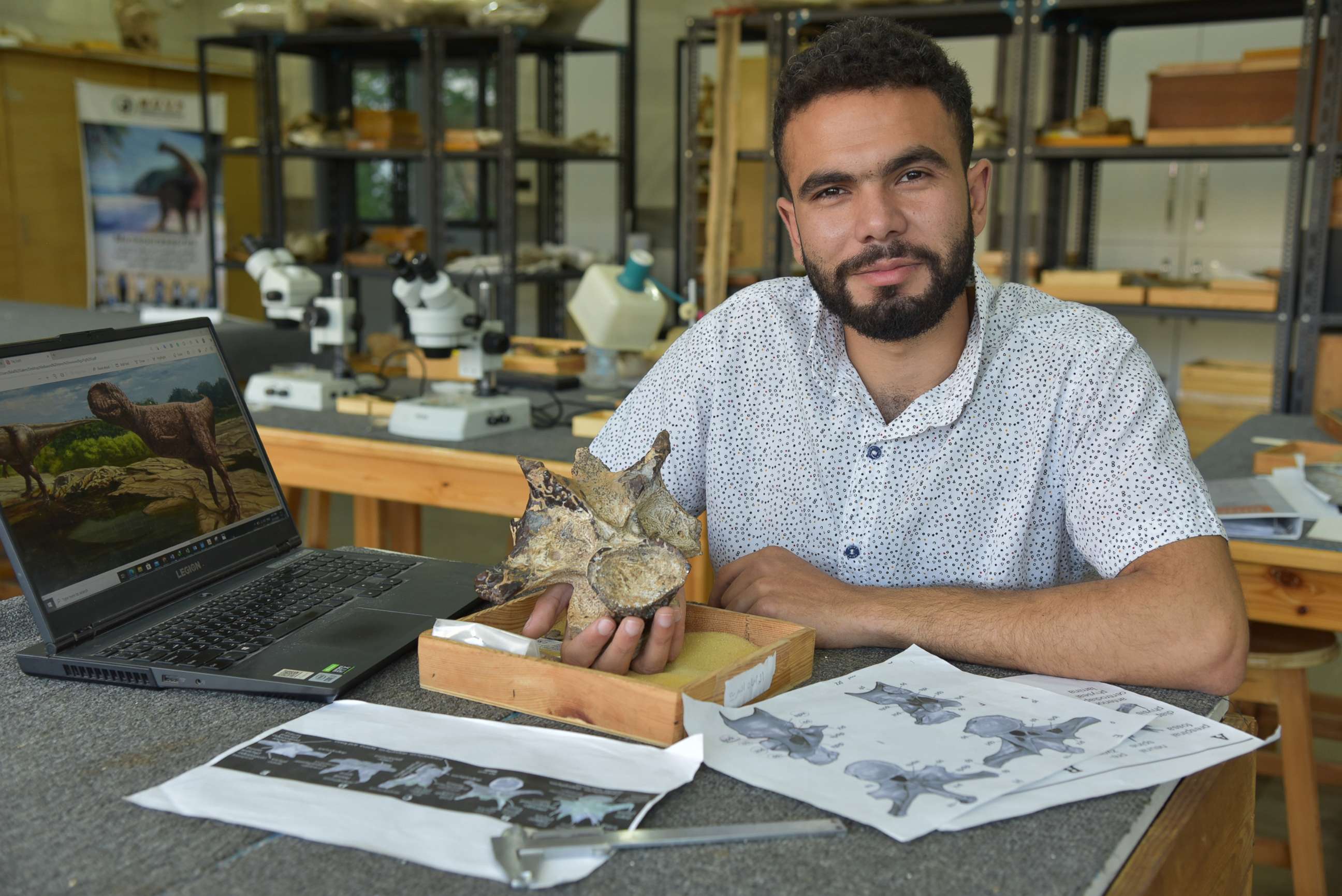 PHOTO: Belal Salem, a member of the Mansoura University Vertebrate Paleontology Center, holds up a vertebra of a dinosaur that lived 98 million years ago.