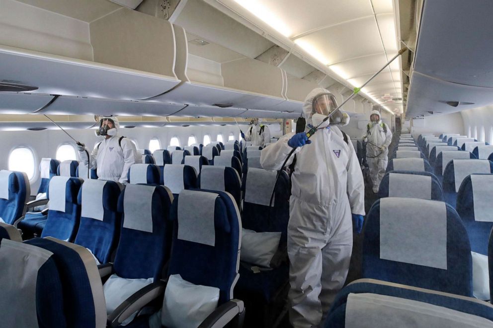PHOTO: Workers wearing protective gear spray disinfectant inside a New York-bound plane, as a precaution against the novel coronavirus, at Incheon International Airport in Incheon, South Korea, on March 4, 2020. 