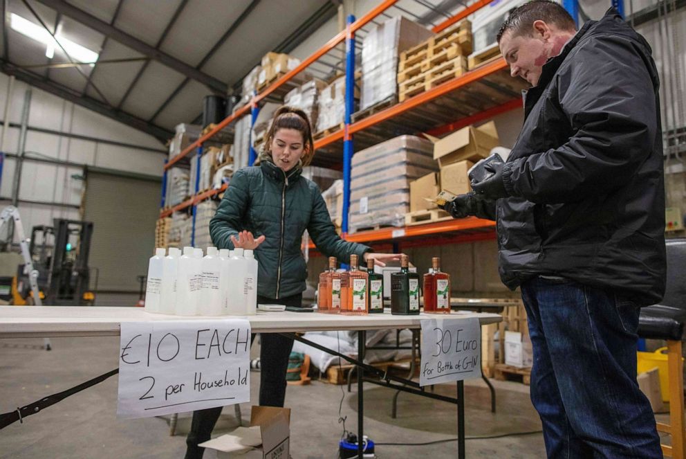 PHOTO: Members of the public queue to buy bottles of hand sanitizer and gin, made and sold at Listoke Distillery and Gin School in Tenure, north of Dublin in Ireland, March 18, 2020.