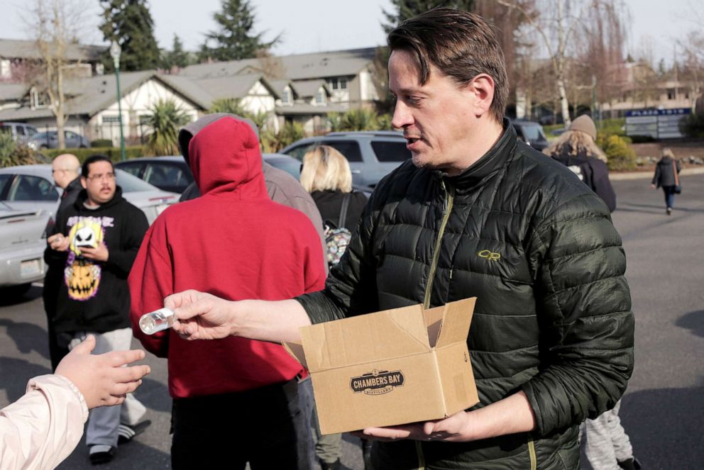 PHOTO: Co-owner Alan Davis distributes free hand sanitizers at Chambers Bay Distillery, which is creating the product and giving it away, during the coronavirus outbreak, in University Place, Washington, March 17, 2020.