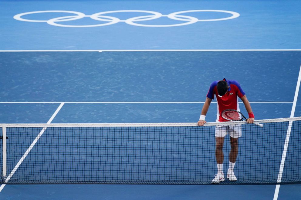 PHOTO: Novak Djokovic, of Serbia, reacts after being defeated by Pablo Carreno Busta, of Spain, in the bronze medal match of the tennis competition at the 2020 Summer Olympics, Saturday, July 31, 2021, in Tokyo, Japan.