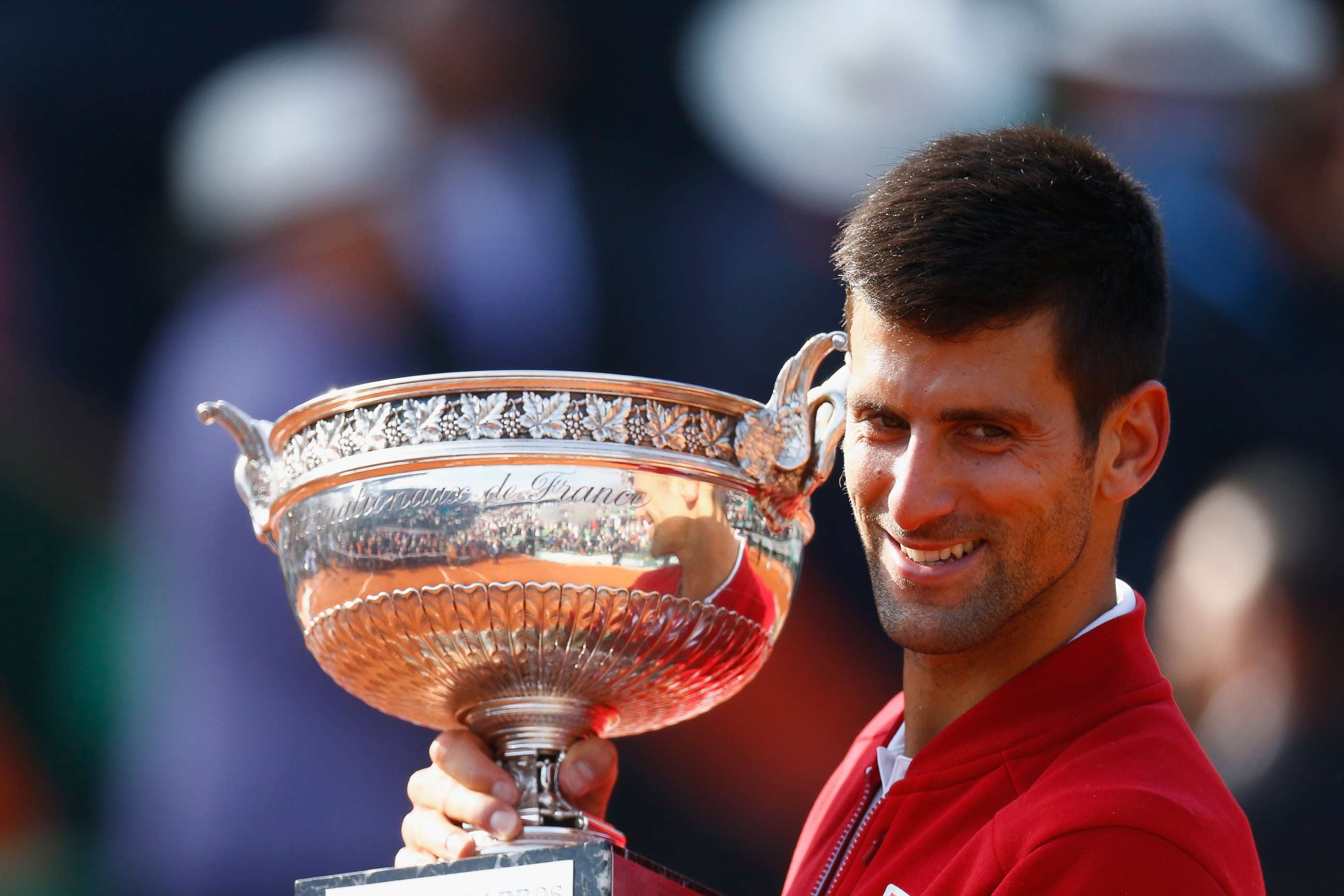 PHOTO: Champion Novak Djokovic poses with the trophy following his victory in the Men's Singles final match against Andy Murray in the French Open at Roland Garros on June 5, 2016, in Paris.