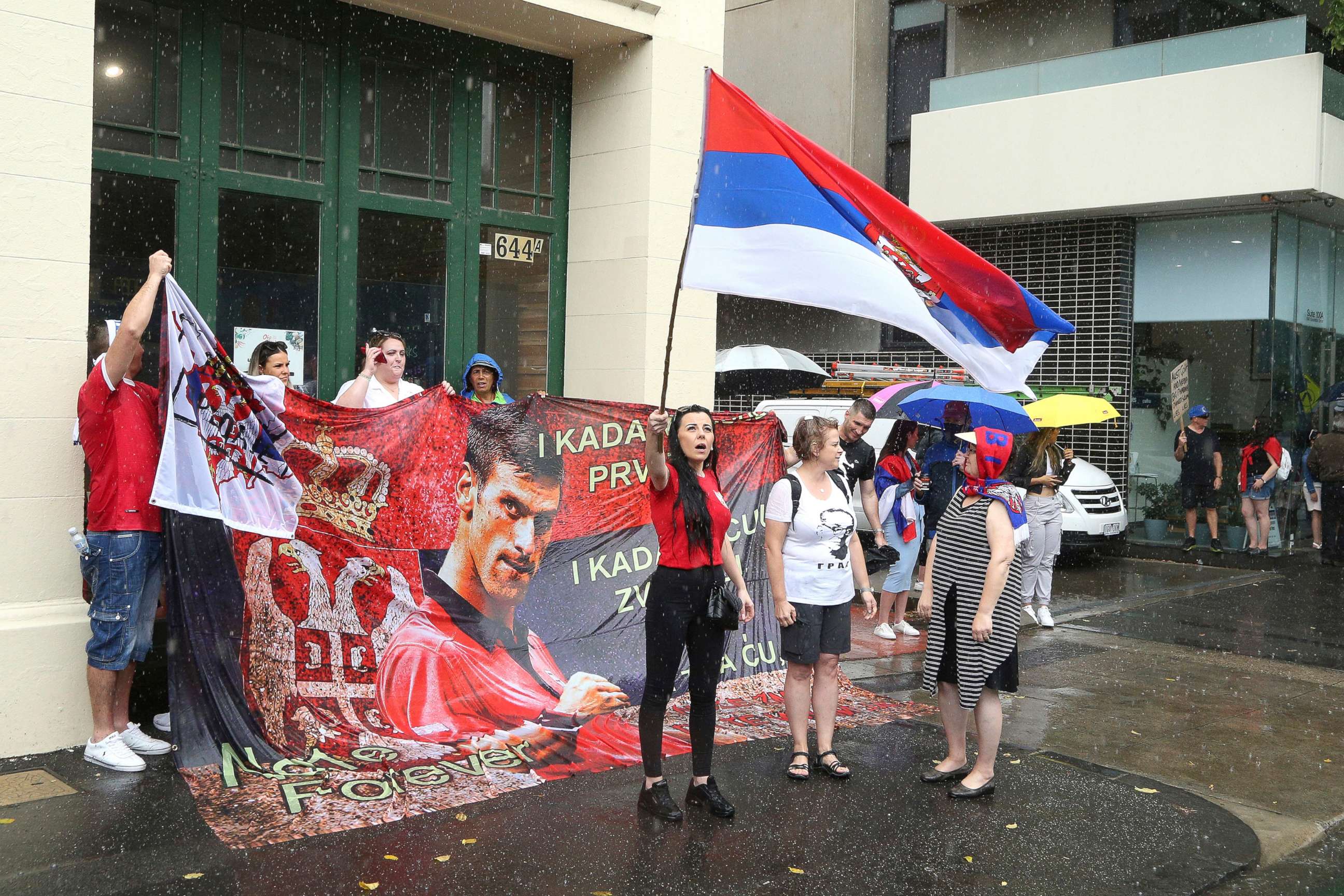 PHOTO: Djokovic supporters gather outside an immigration detention hotel where Serbia's Novak Djokovic is believed to be staying in Melbourne, Australia, Jan. 7, 2022.