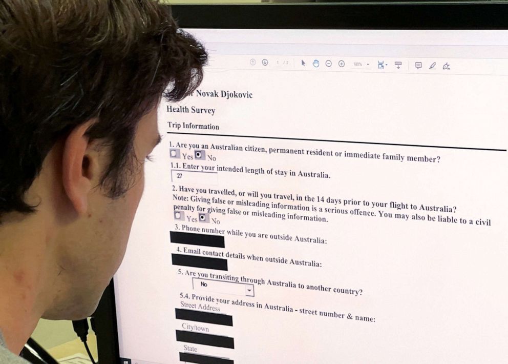 PHOTO: A journalist looks at a copy of Serbian tennis champion Novak Djokovic's health survey submitted during his Australian visa application process on a computer screen in Hong Kong, Jan. 11, 2022.