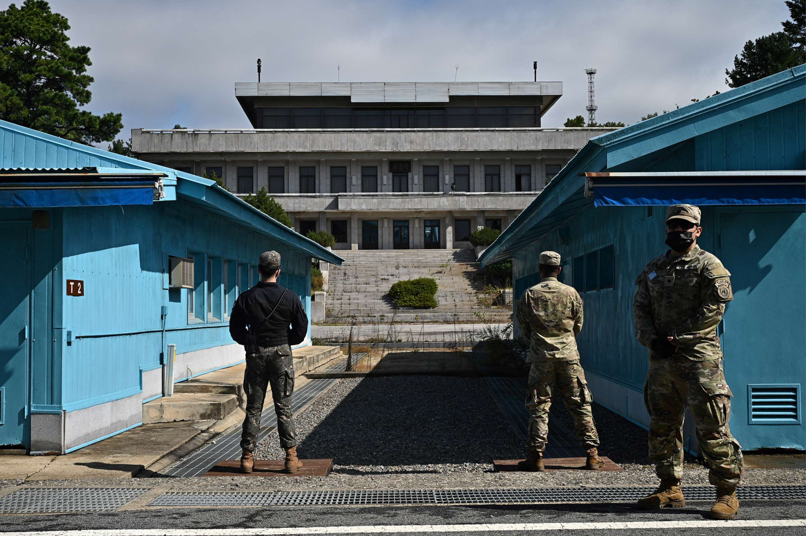 PHOTO: (United Nations Command soldiers and a South Korean soldier stand guard before North Korea's Panmon Hall and the military demarcation line separating North and South Korea, at Panmunjom, in the Demilitarized Zone, on October 4, 2022.