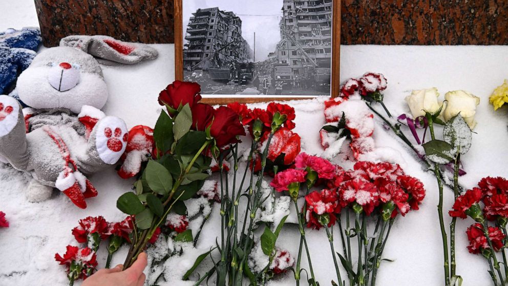 PHOTO: A person lays flowers in memory of those killed in the weekend missile strike on a residential block in the Ukrainian city of Dnipro, at the monument to famous Ukrainian poetess Lesya Ukrainka in Moscow on Jan. 17, 2023.