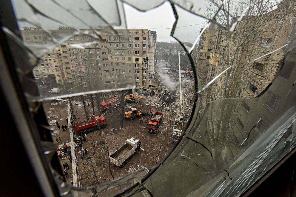 PHOTO: A damaged residential building is seen through a broken window as rescue work continues, in Dnipro, southeastern Ukraine, Jan. 15, 2023 after a Jan. 14 missile strike. At least 40 people were killed.