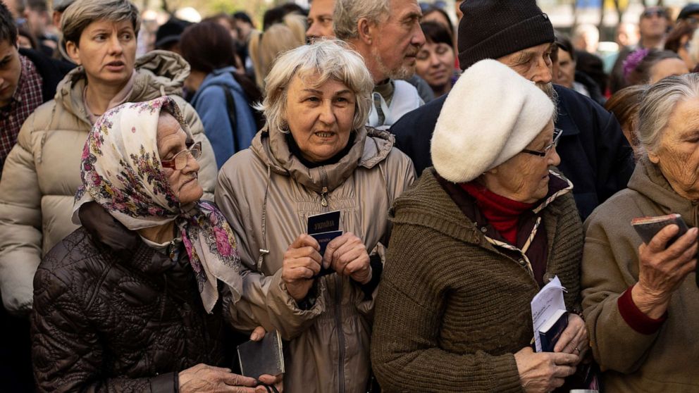 PHOTO: Internally displaced people who were evacuated from the east of the country line up to receive food donations at the Catholic Church of Saint Joseph in Dnipro, Ukraine, May 3, 2022.
