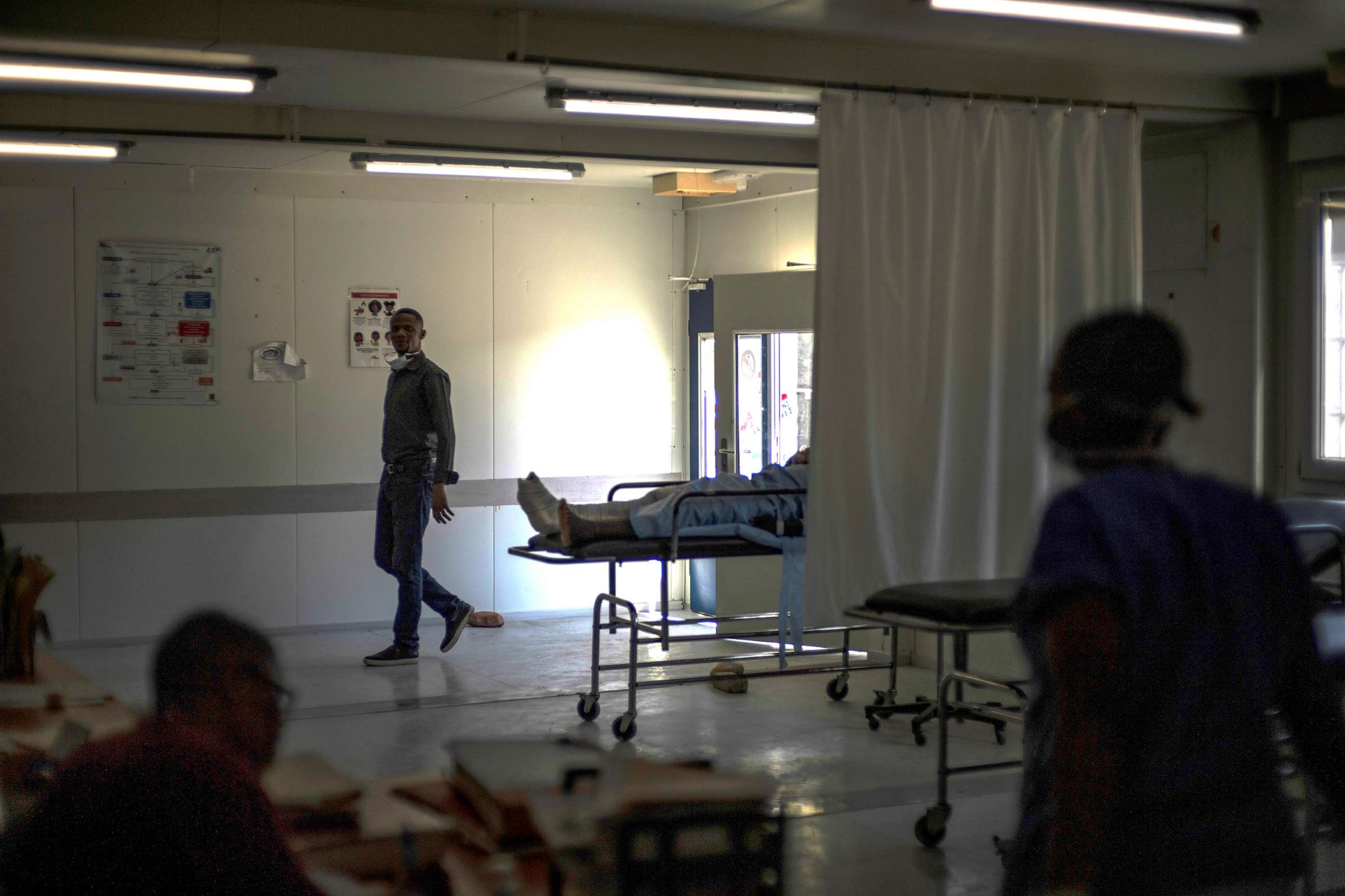 PHOTO: In this Nov. 3, 2022, file photo, medical staff walk past a stretcher with gunshot patient at a clinic run by Doctors Without Borders in the Tabarre neighborhood of Port-au-Prince, Haiti.