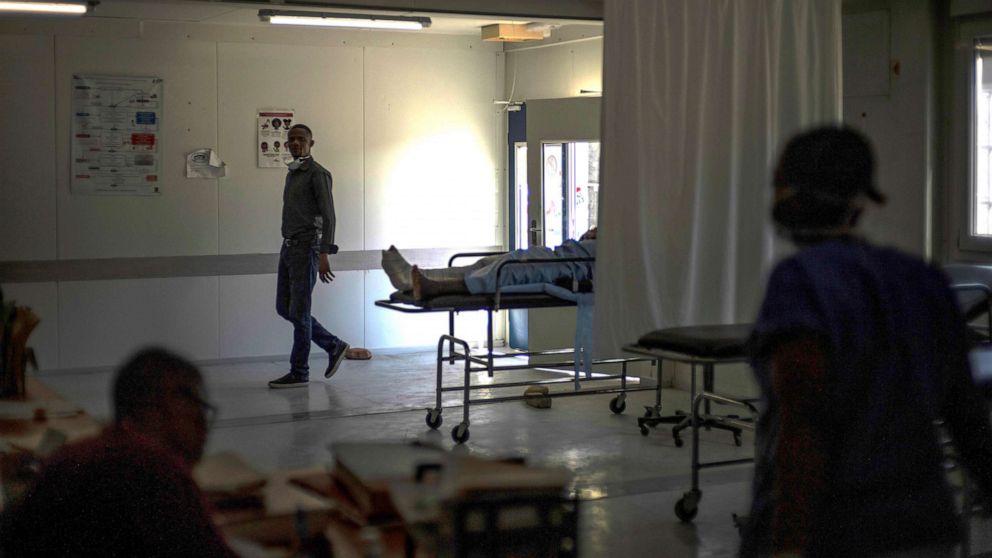 PHOTO: In this Nov. 3, 2022, file photo, medical staff walk past a stretcher with gunshot patient at a clinic run by Doctors Without Borders in the Tabarre neighborhood of Port-au-Prince, Haiti.