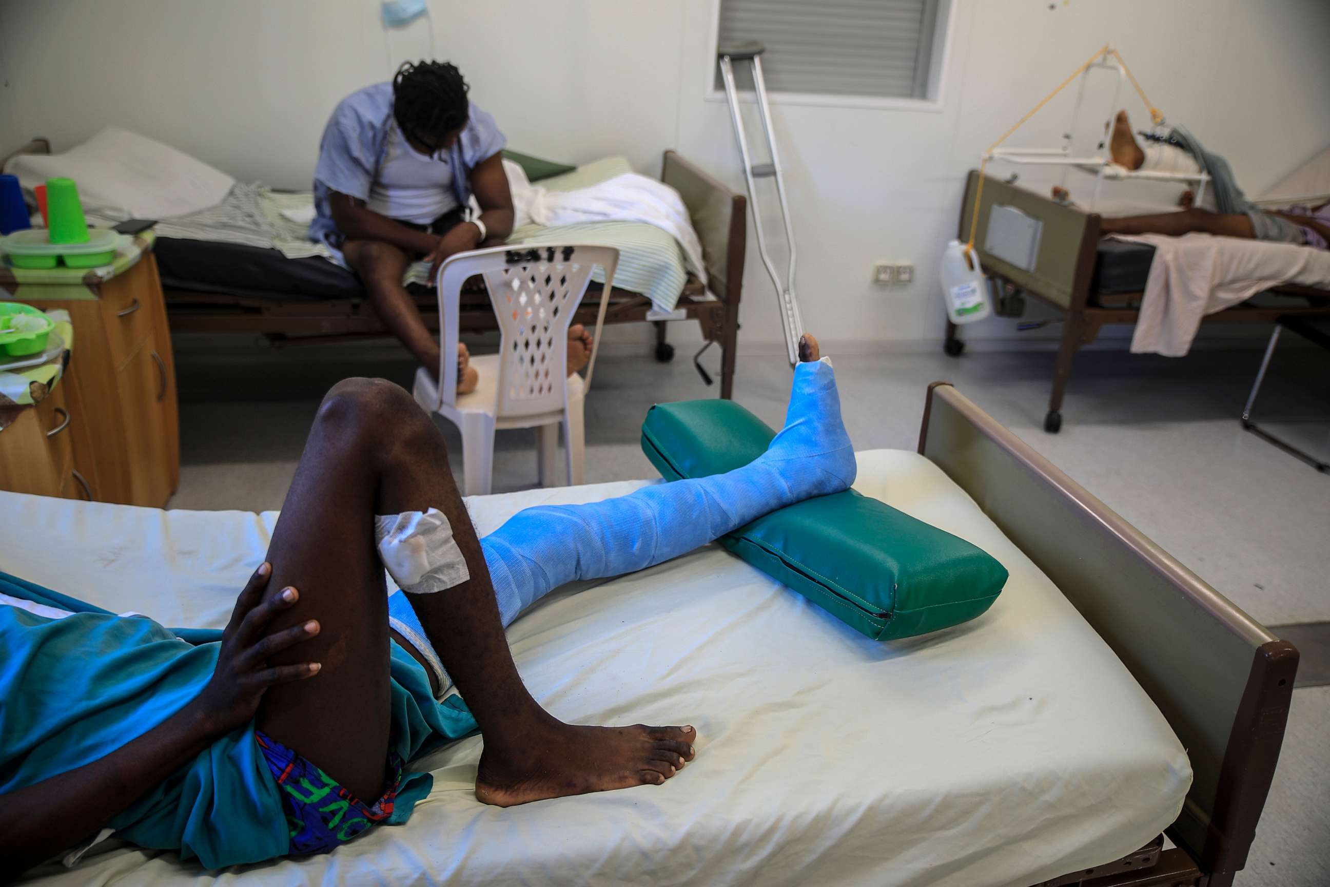 PHOTO: In this Jan. 25, 2023, file photo, a man who was shot in his left foot by a stray bullet, lies on a bed at a clinic run by Doctors Without Borders in the Tabarre neighborhood of Port-au-Prince, Haiti.