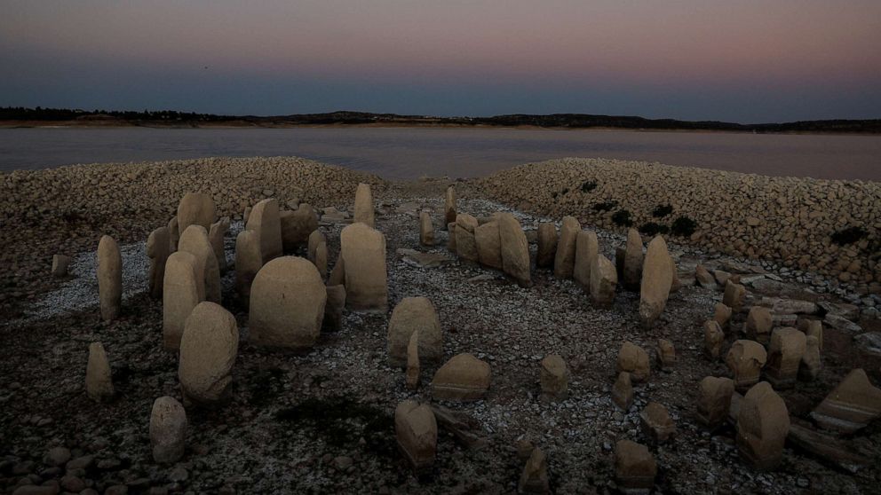 PHOTO: The dolmen of Guadalperal, also known as the Spanish Stonehenge, is revealed due to the receding waters of the Valdecanas reservoir in the outskirts of El Gordo, Spain, Aug, 3, 2022.