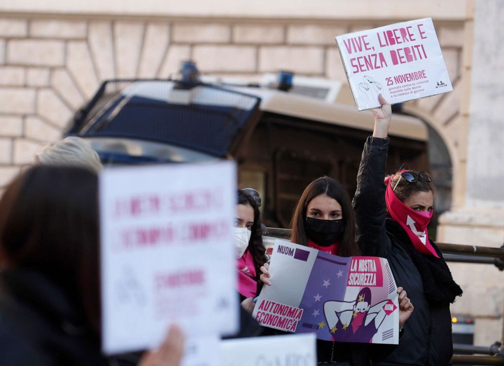 PHOTO: A woman show a banner reading "alive, free and without debts" during a demonstration on the occasion of International Day for the Elimination of Violence against Women, in Rome, Nov. 25, 2020.