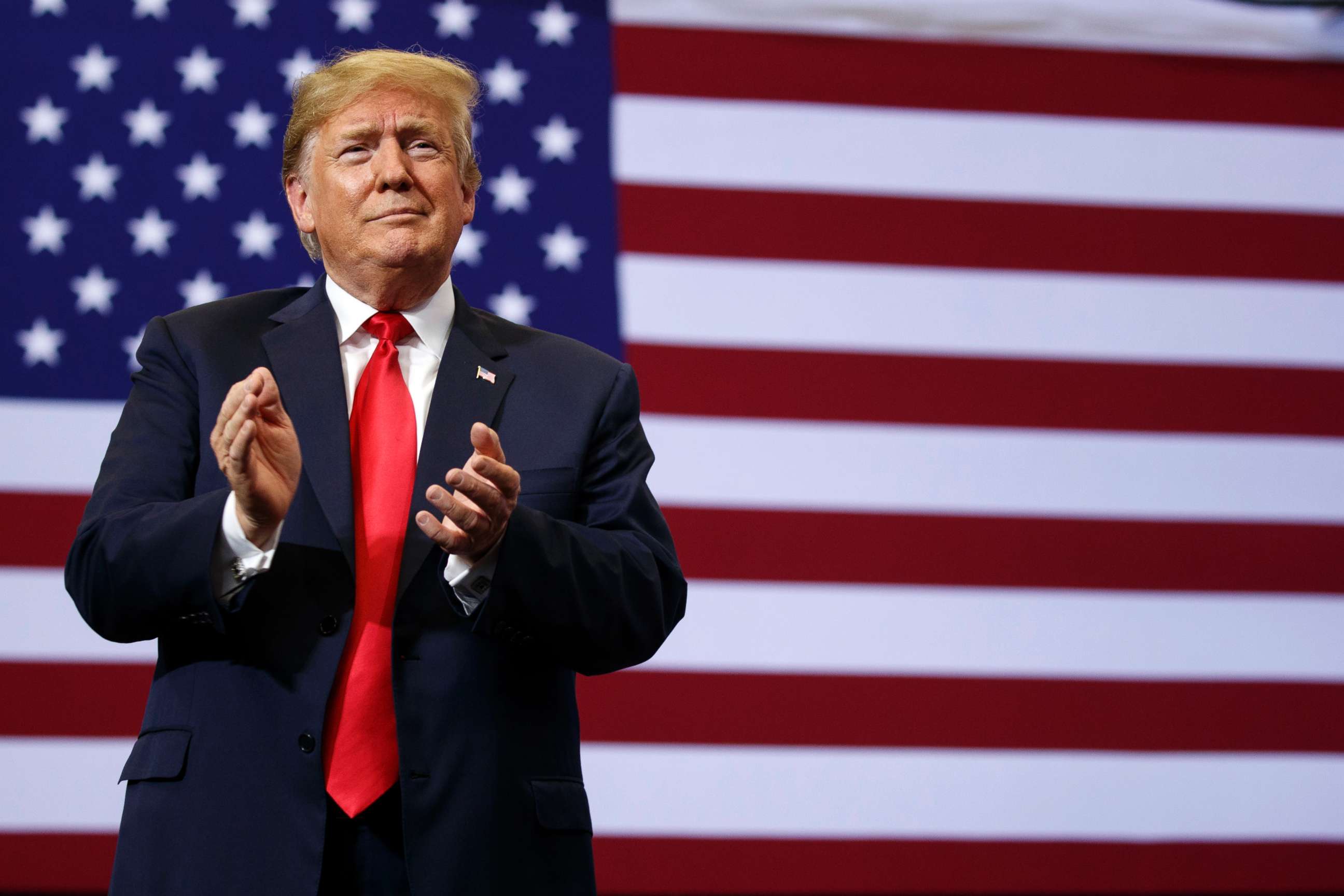 PHOTO: President Donald Trump claps as he arrives for a campaign rally, June 27, 2018, in Fargo, N.D.