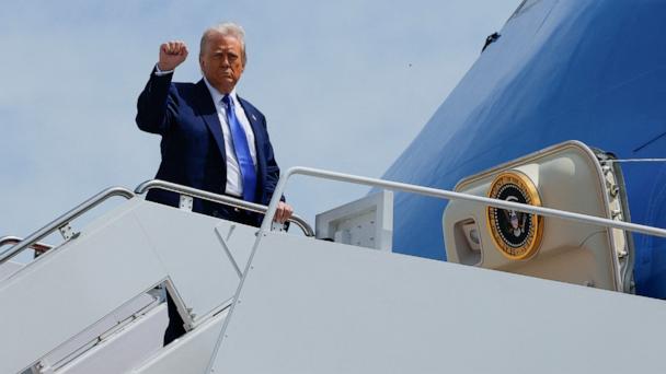 President Donald Trump gestures, while he boards Air Force One, as he departs for Saudi Arabia, Qatar and the United Arab Emirates, at Joint Base Andrews, in Maryland, May 12, 2025. 