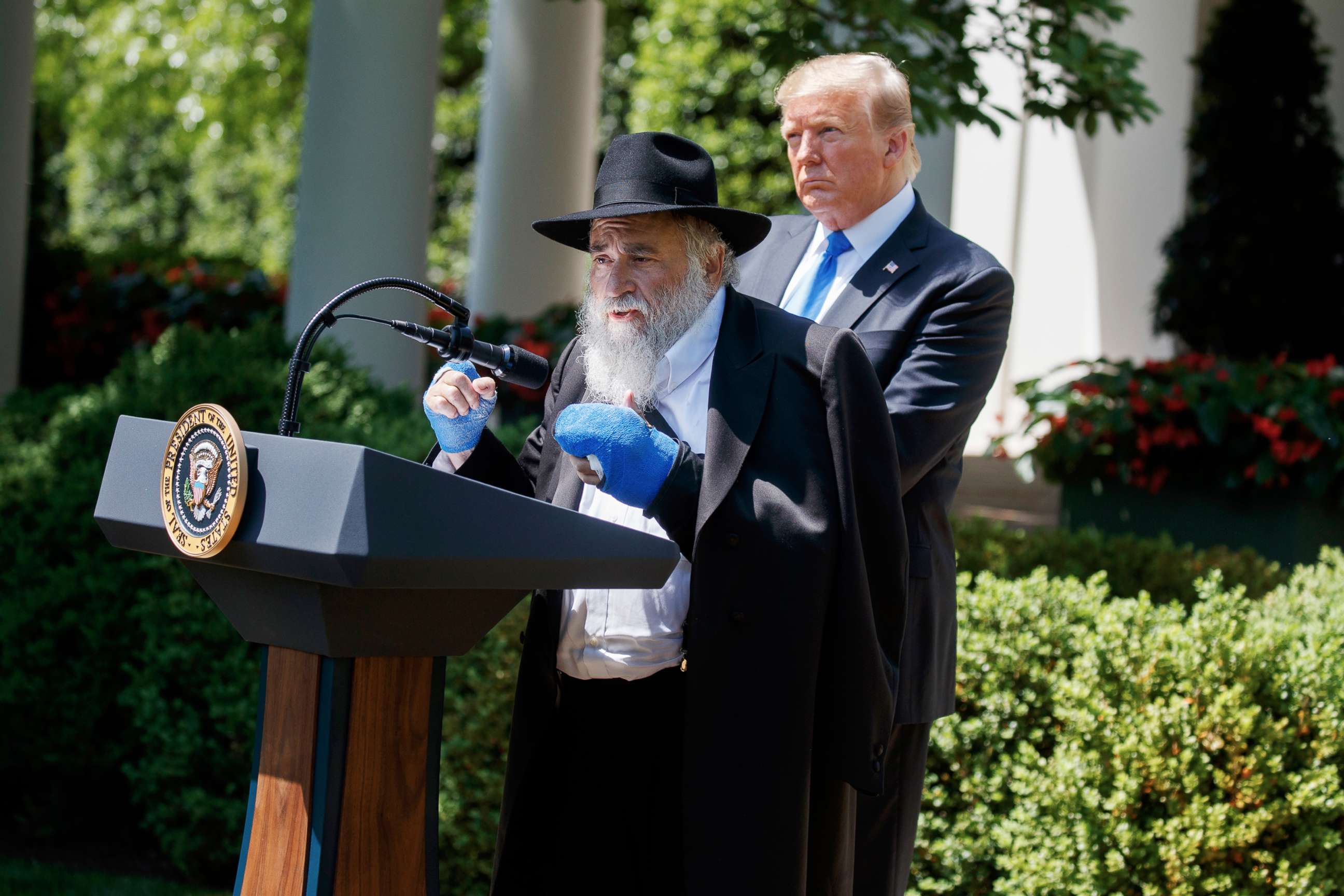 PHOTO: President Donald Trump looks on as Rabbi Yisroel Goldstein, survivor of the Poway, Calif synagogue shooting, speaks during a National Day of Prayer event in the Rose Garden of the White House, Thursday, May 2, 2019, in Washington.