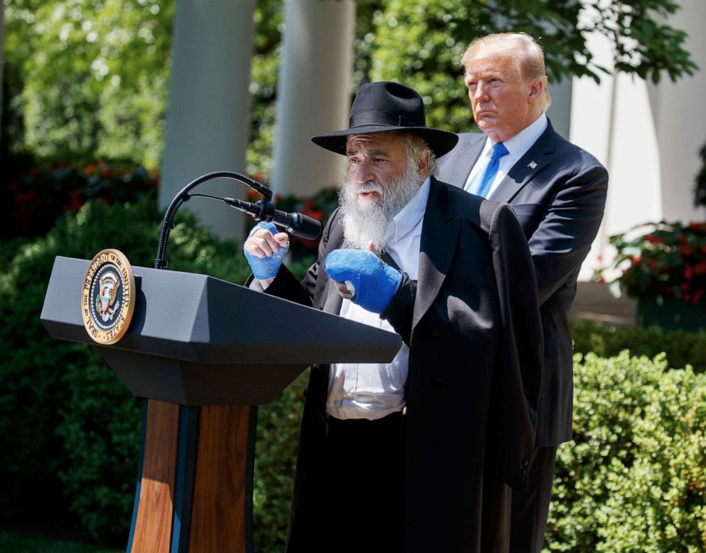 PHOTO: President Donald Trump looks on as Rabbi Yisroel Goldstein, survivor of the Poway, Calif synagogue shooting, speaks during a National Day of Prayer event in the Rose Garden of the White House, Thursday, May 2, 2019, in Washington.