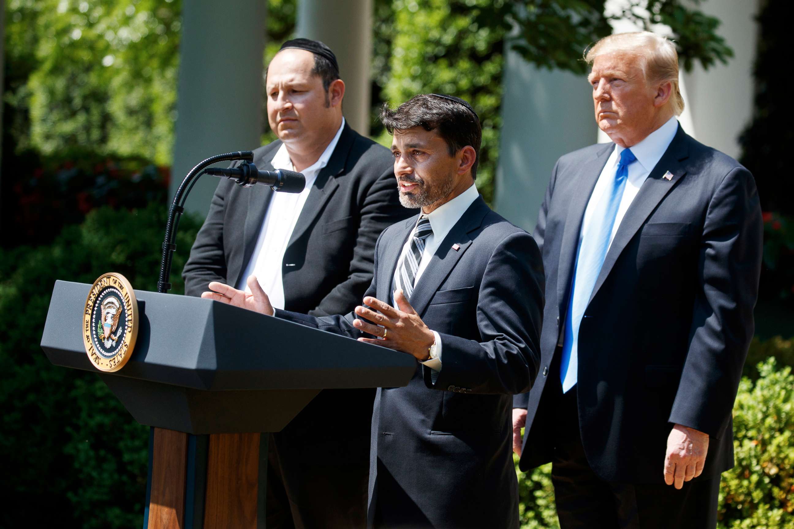 PHOTO: Jonathan Morales, left, and President Donald Trump, look on as Oscar Stewart speaks during a National Day of Prayer event in the Rose Garden of the White House, Thursday, May 2, 2019, in Washington.