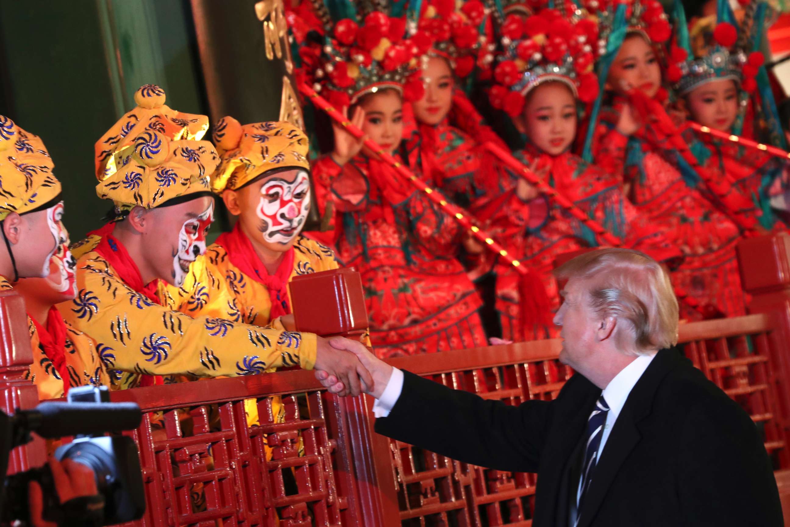 PHOTO: President Donald Trump shakes hands with an opera performer during a tour of an opera performance at the Forbidden City, Nov. 8, 2017, in Beijing, China. 